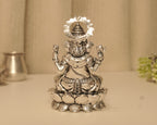 Back of the large silver Ganesh idol, showing the crown within the beaded arch.