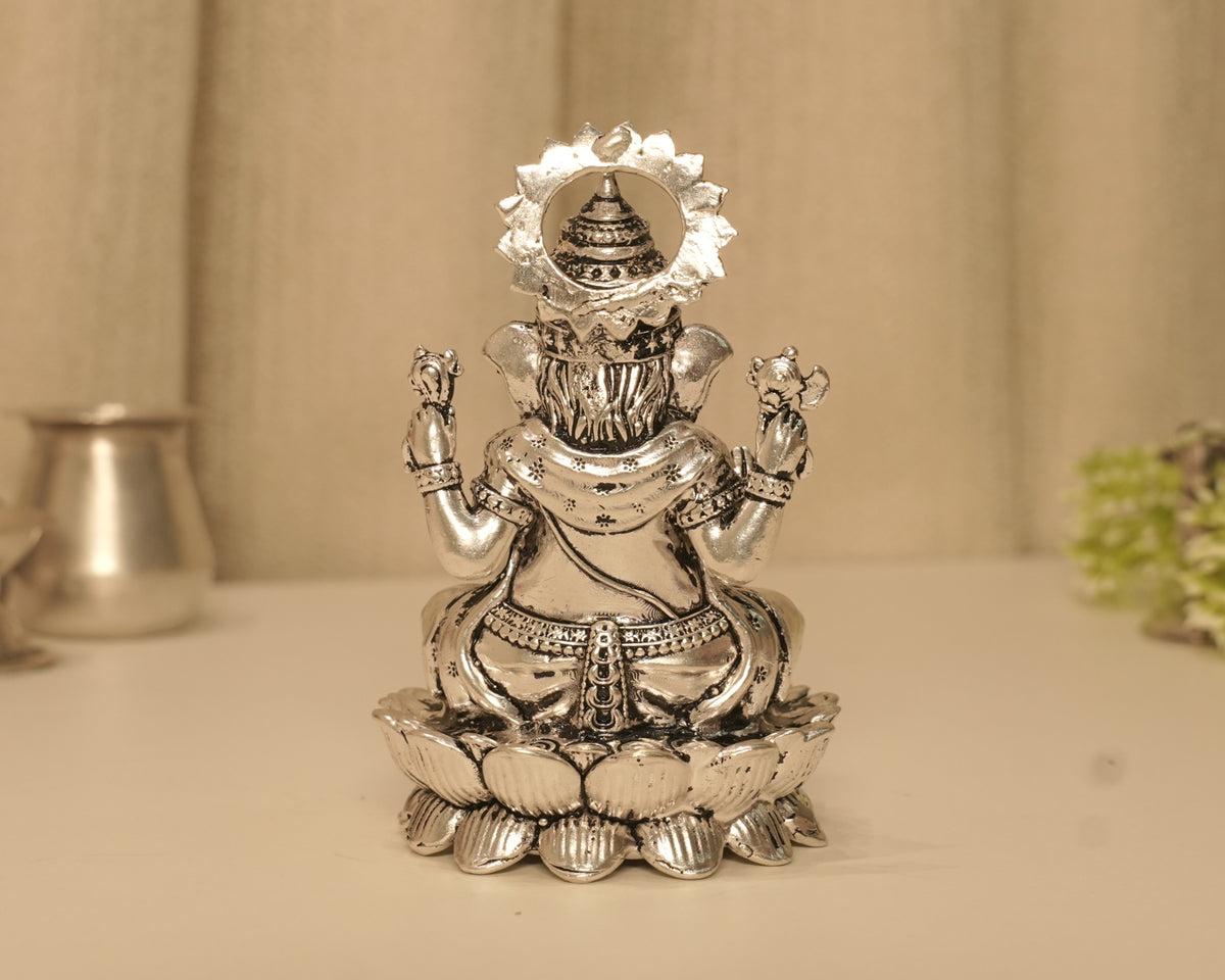 Back of the large silver Ganesh idol, showing the crown within the beaded arch.