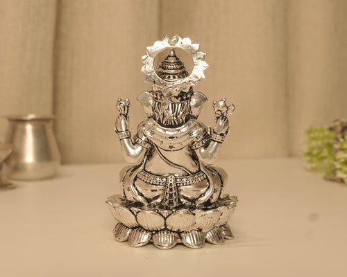 Back of the large silver Ganesh idol, showing the crown within the beaded arch.