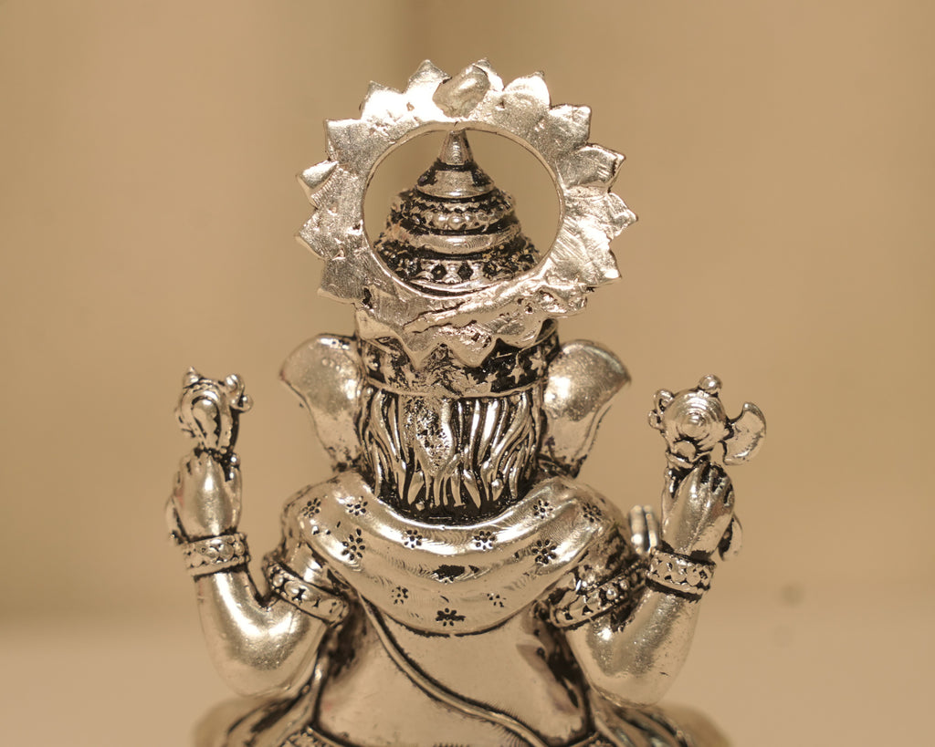Close view of the back of the large silver Ganesh idol, showing the flowers worked into the dhoti.