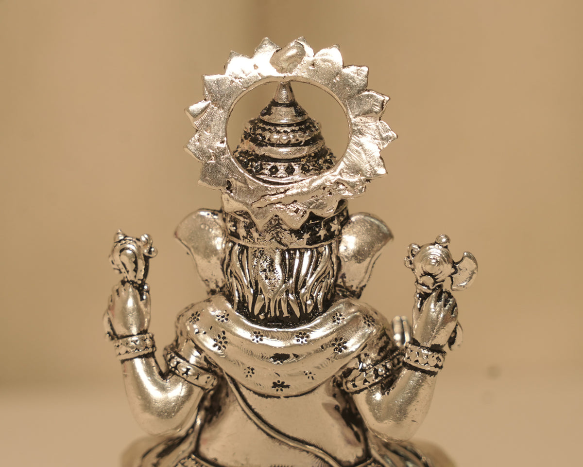 Close view of the back of the large silver Ganesh idol, showing the flowers worked into the dhoti.
