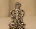 Close view of the antique silver Ganesh figure, the crown, the trunk and the Om marked on his palm.