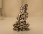 Side view of the antique silver Ganesh idol, showing the crown and the lotus base in profile.