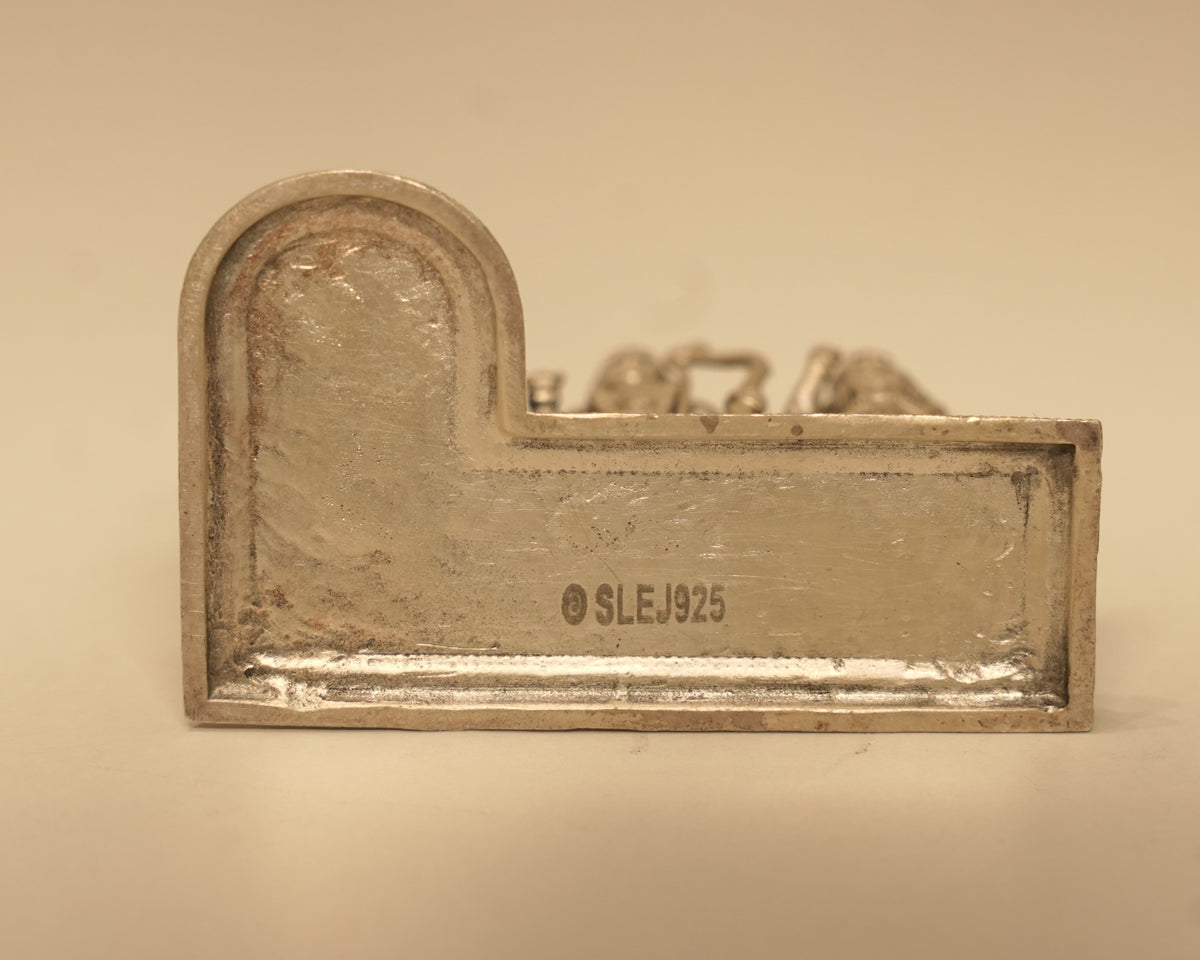 The plain back of the silver Ram Darbar arch, showing the silver mark stamped into it.