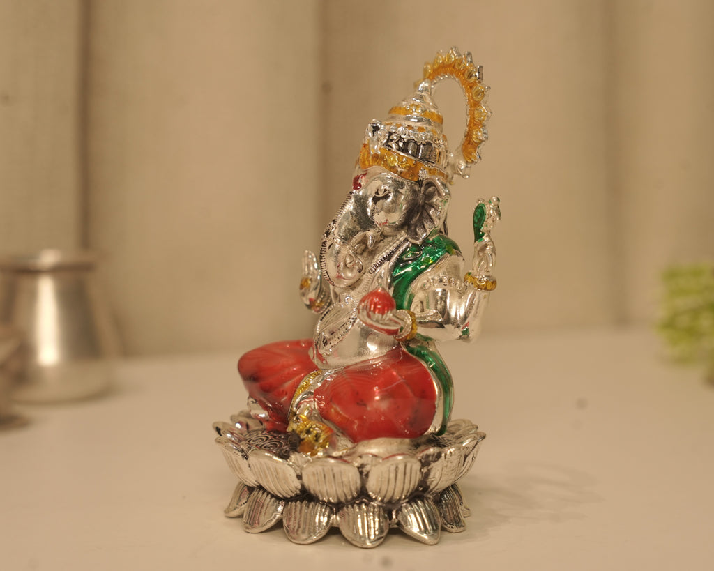 Side view of the enamelled silver Ganesh idol, showing the crown and the lotus base in profile.