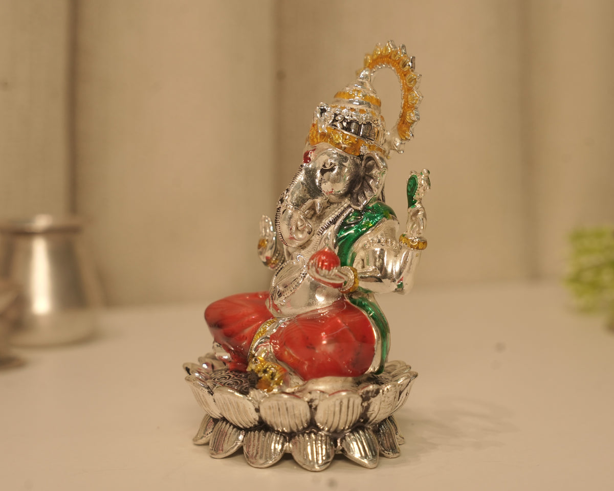 Side view of the enamelled silver Ganesh idol, showing the crown and the lotus base in profile.