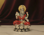 Large sterling silver Lakshmi idol in a red enamel saree and green blouse, seated on a silver lotus base.
