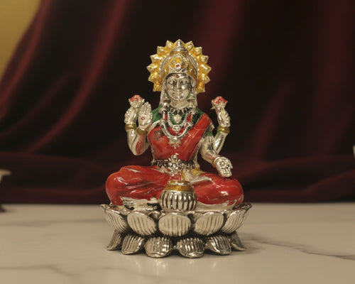 Large sterling silver Lakshmi idol in a red enamel saree and green blouse, seated on a silver lotus base.