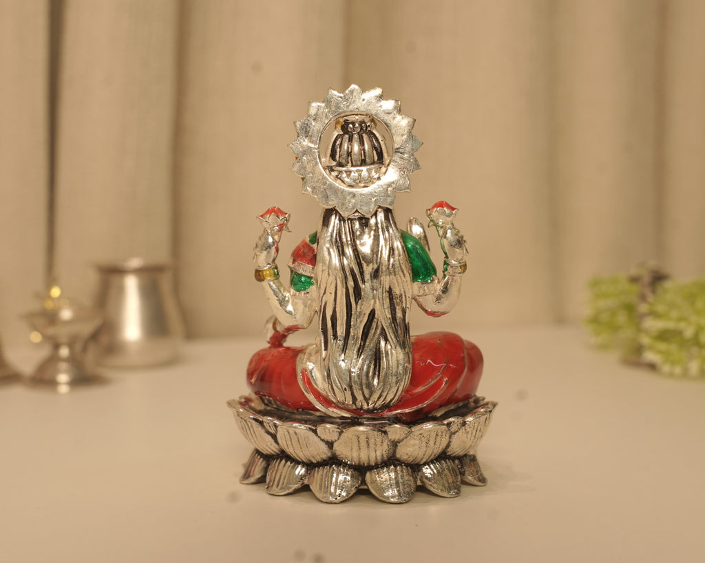 Back of the enamelled silver Lakshmi idol, showing the crown set within the disc.