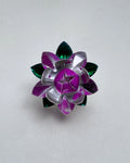Sterling silver lotus flower seen from above, with deep pink enamel inner petals and green enamel leaves.
