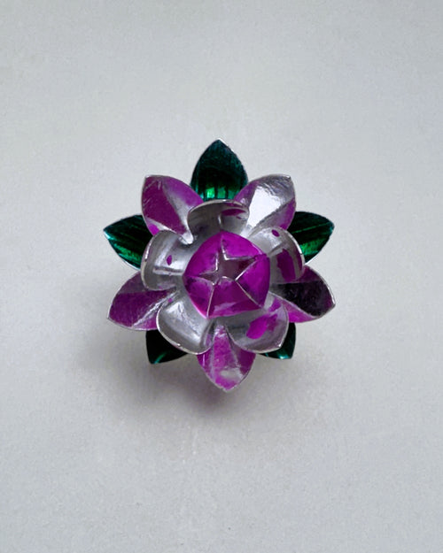 Sterling silver lotus flower seen from above, with deep pink enamel inner petals and green enamel leaves.