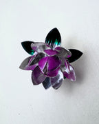 The silver lotus at an angle, showing the layered petals in silver, pink and green.
