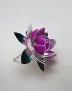 Side view of the silver lotus, showing the stem and the green enamel leaves underneath.