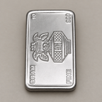 10 gram fine silver bar with a kalash and swastik on the face, stamped 10 gram 999 fine, on a beige surface.