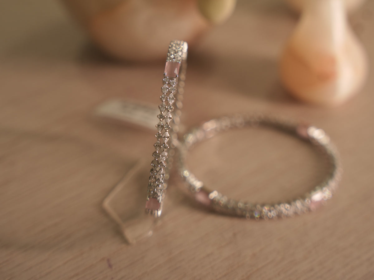 Sterling silver bangle standing upright, showing the American Diamond lattice open at a pink rectangular stone.
