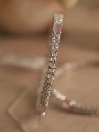 Close view of the bangle surface, with rows of small American Diamond around a flush set pink stone.