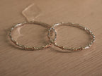 Pair of slim two-tone sterling silver bangles lying flat, with rose-tone sections alternating around the bands.