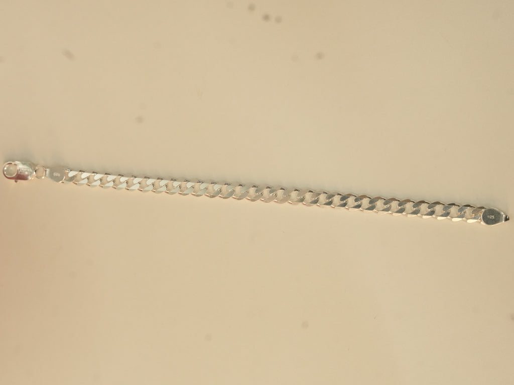 The curb chain bracelet laid out straight, showing its full length.