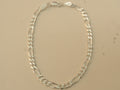 Sterling silver figaro chain bracelet laid in an oval, closed at the lobster clasp.