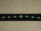 Sterling silver bracelet of prong-set sea-green oval stones with a pear-shaped centre stone, spaced by round cubic zirconia, displayed on black velvet.