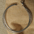 textured link bracelet on beige fabric.