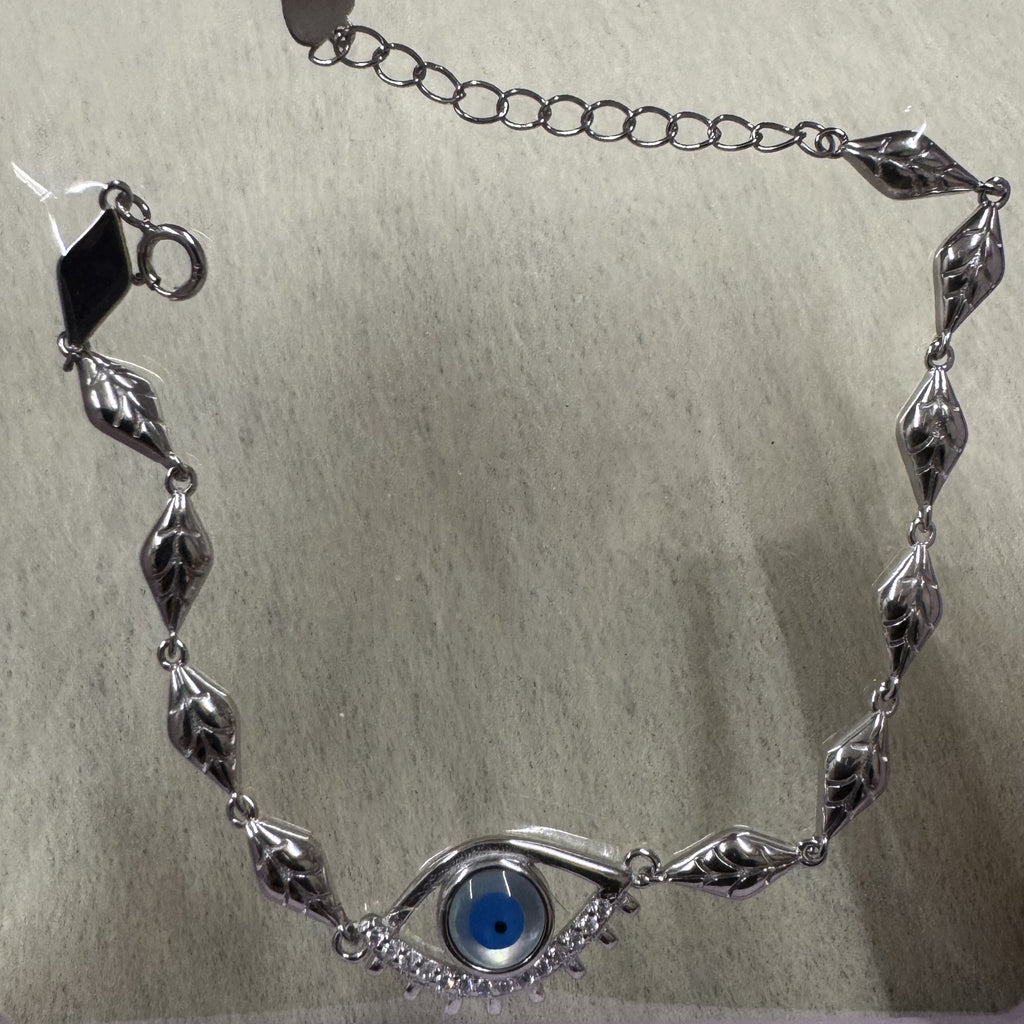 Sterling silver evil eye bracelet laid in a curve, showing the leaf-engraved marquise links, extender chain and clasp.