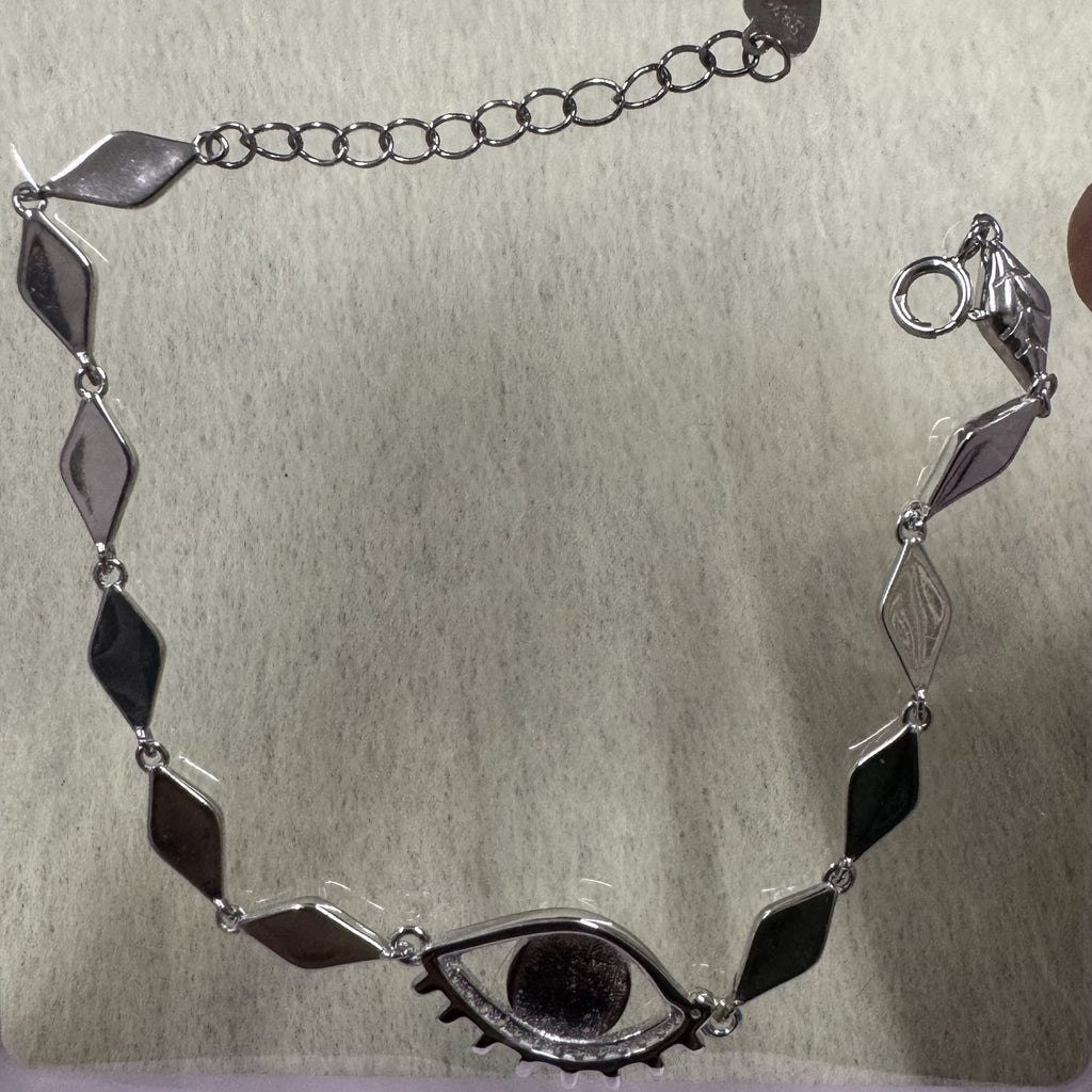 Low-light view of the sterling silver nazar bracelet showing the full run of marquise links and the extender chain.