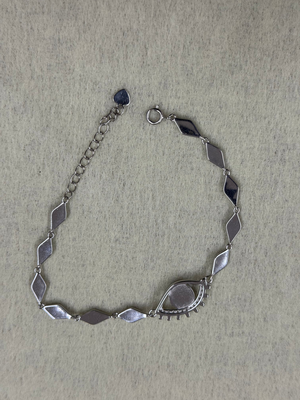 Reverse of the sterling silver nazar bracelet, showing the plain flat backs of the marquise links and the closed back of the eye.