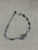 Reverse of the sterling silver nazar bracelet, showing the plain flat backs of the marquise links and the closed back of the eye.
