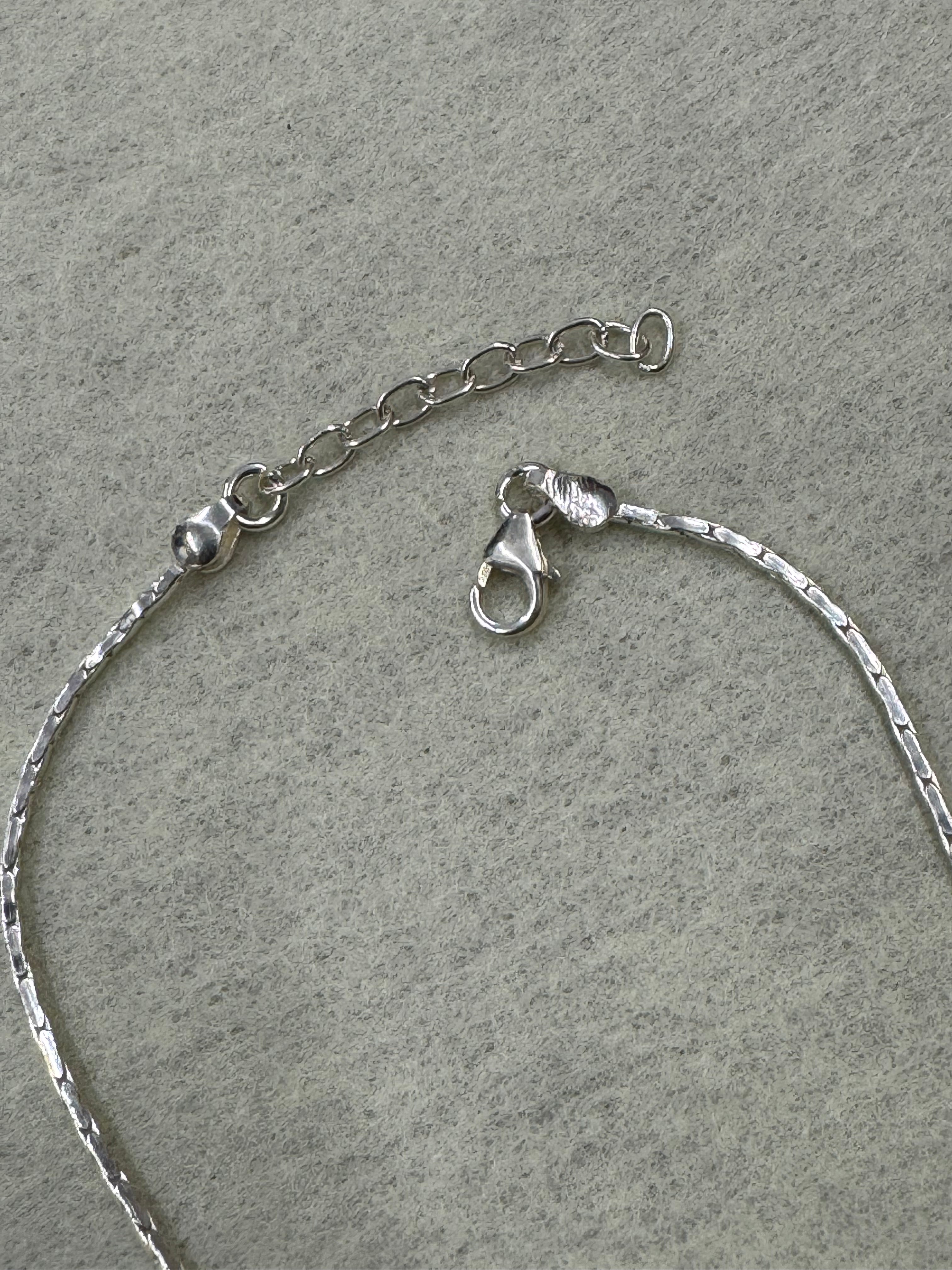 Lobster clasp and extender chain on the fine flat sterling silver chain.