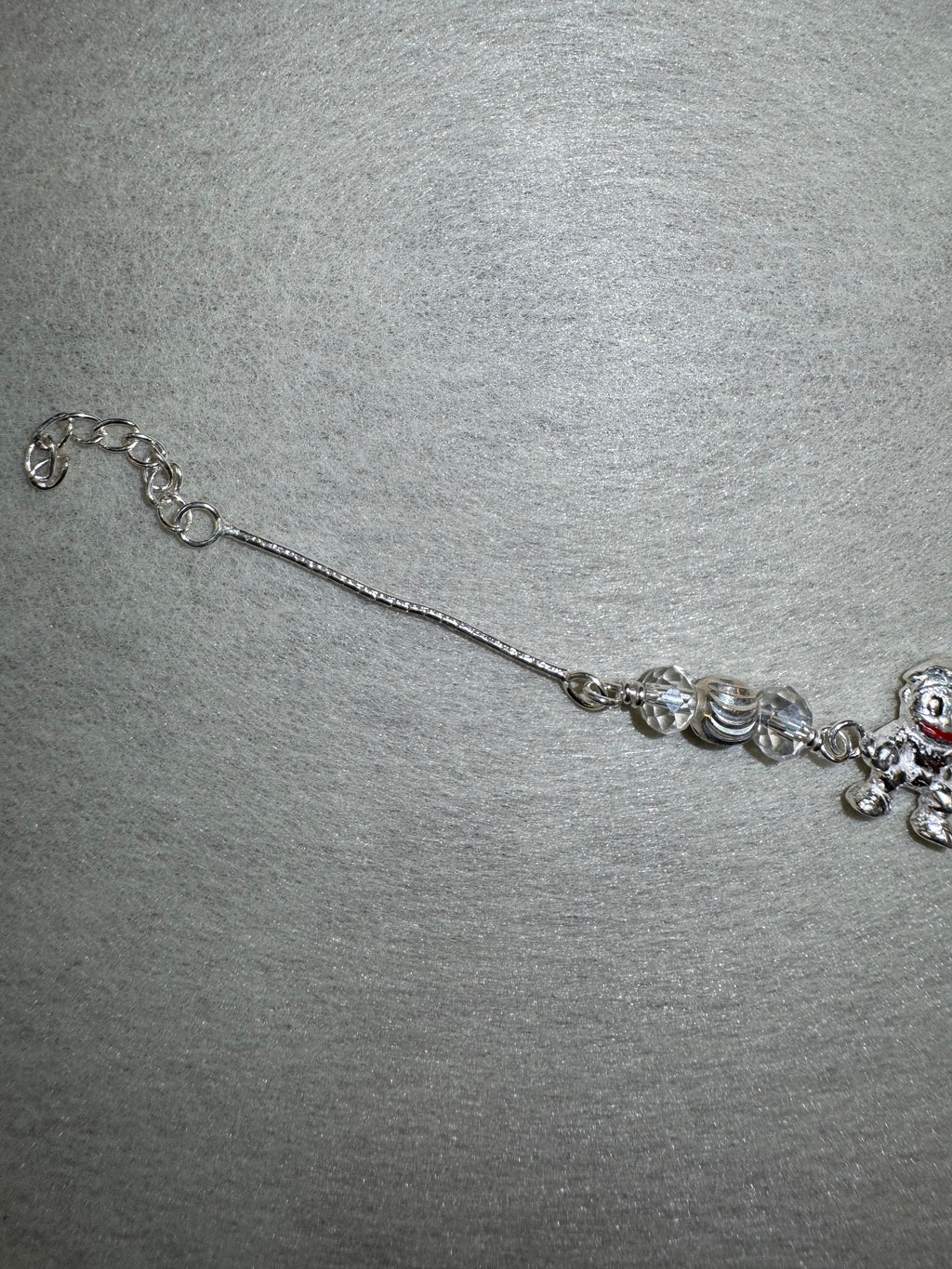 Lower half of the sterling silver charm bracelet, showing the second bead station and the extender chain.