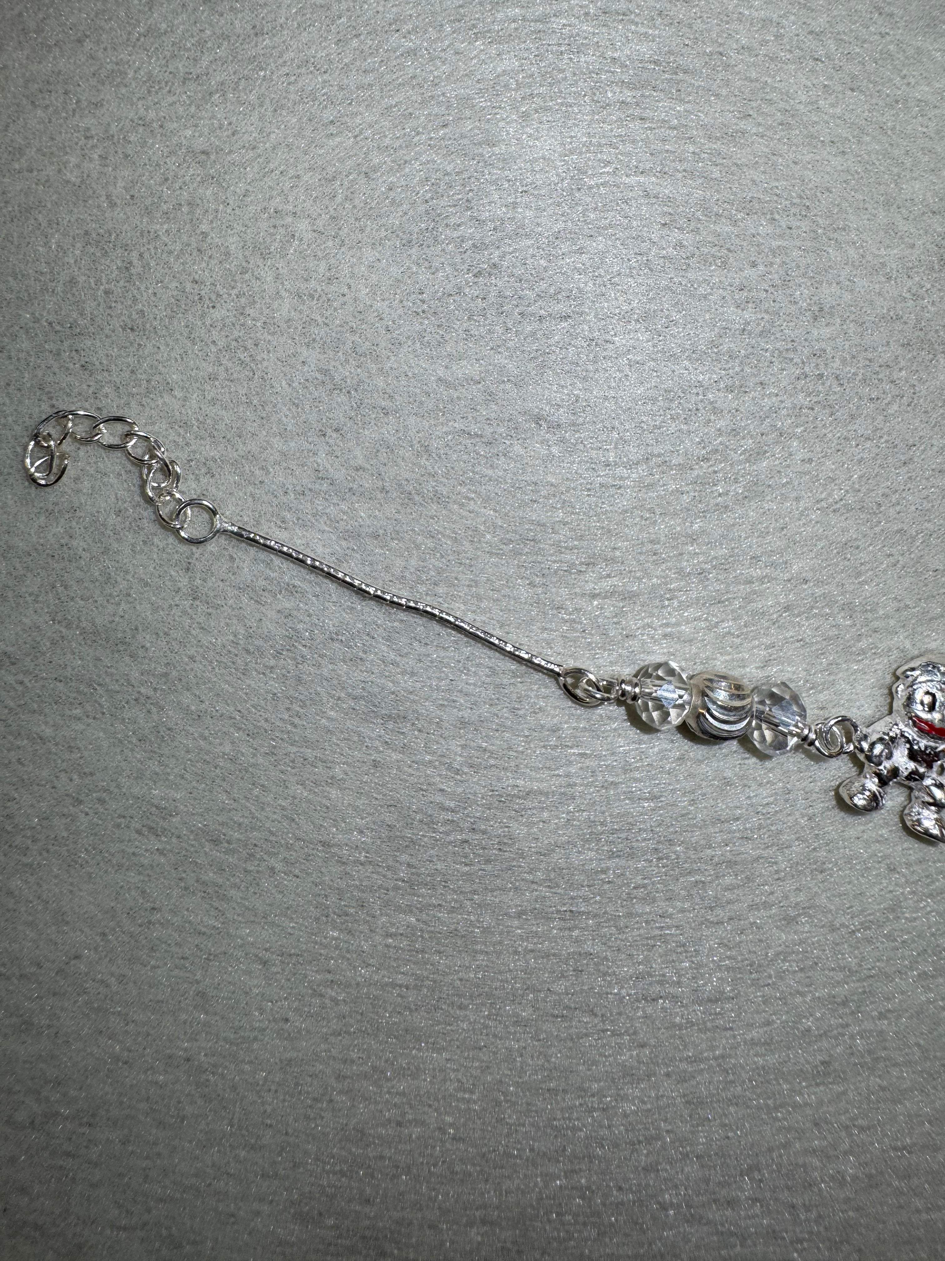 Lower half of the sterling silver charm bracelet, showing the second bead station and the extender chain.