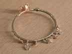 The lily bracelet at an angle, showing the alternating flowers and stone set discs.