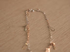 The starburst link bracelet laid open, showing the alternating silver and rose-tone links.