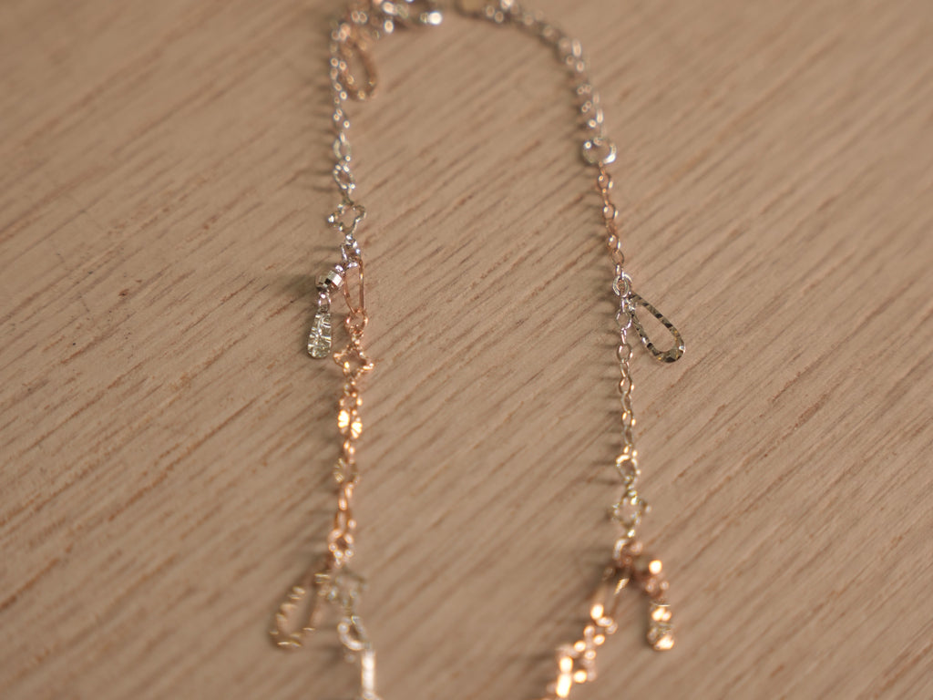 Close view of the starburst discs and clover links on the fine chain.