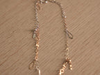 Close view of the starburst discs and clover links on the fine chain.