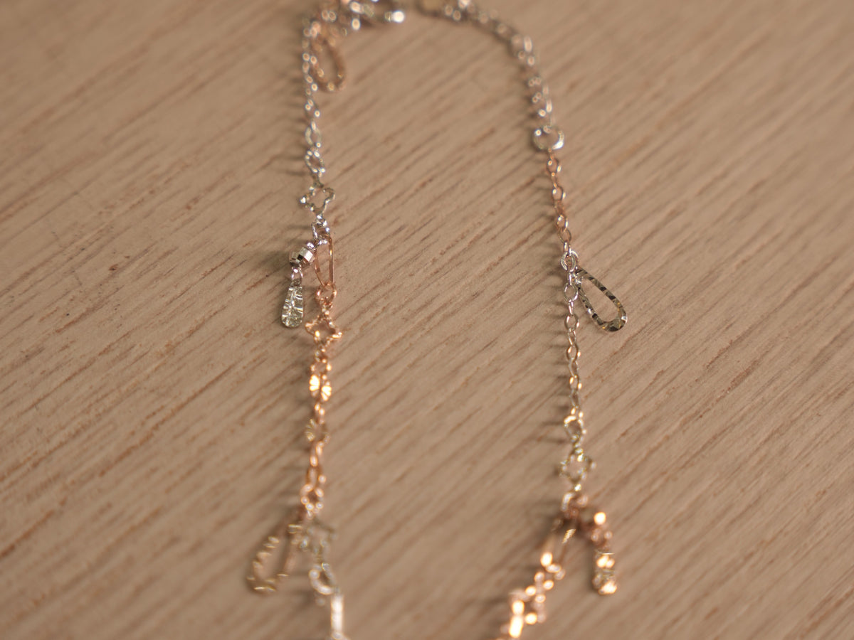 Close view of the starburst discs and clover links on the fine chain.