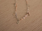 The full length of the two-tone chain bracelet laid out on a pale surface.