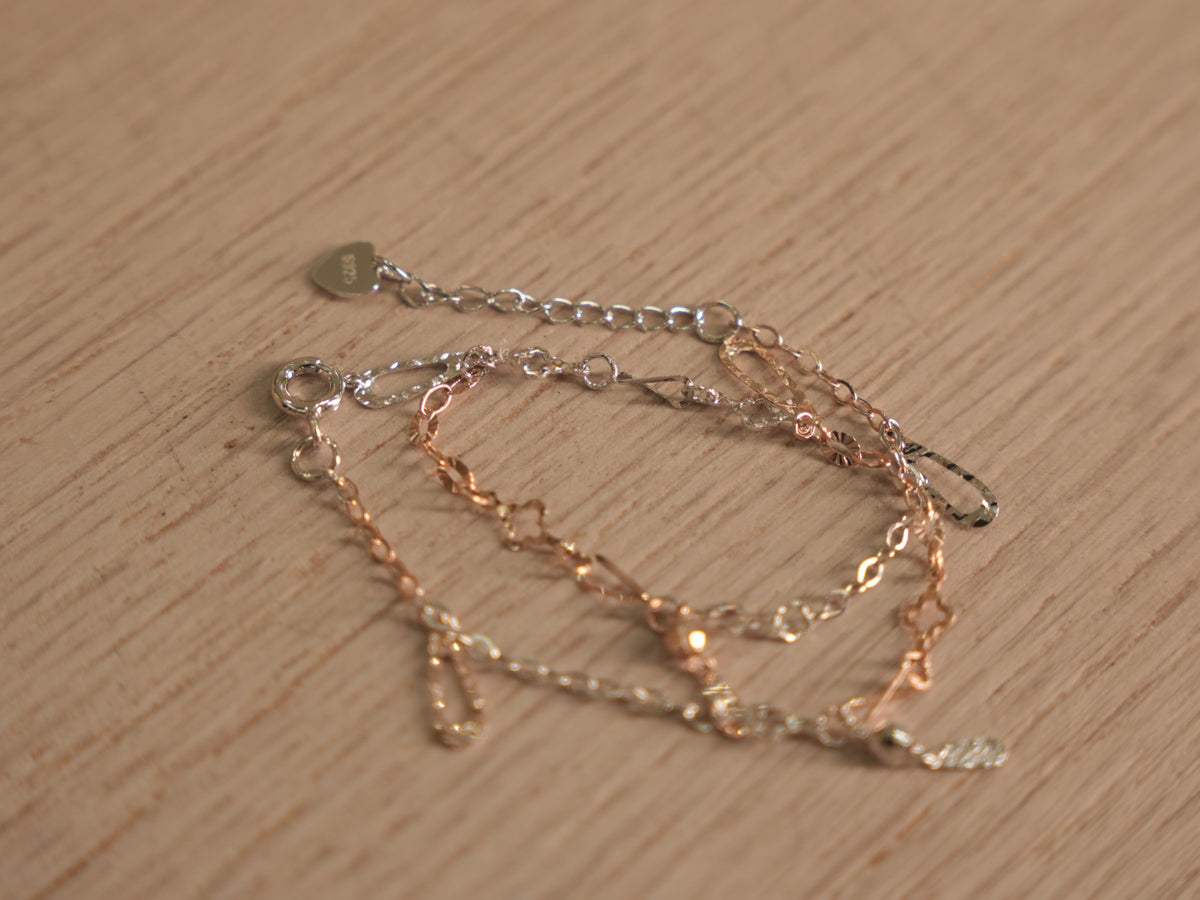 Angled view of the chain bracelet, showing the light catching the textured links.