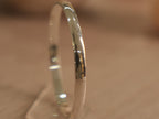 Close view of the kids kada, showing the bright polish and rounded edges.