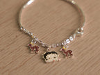 Close view of the spotted enamel deer charms on the kids bracelet chain.