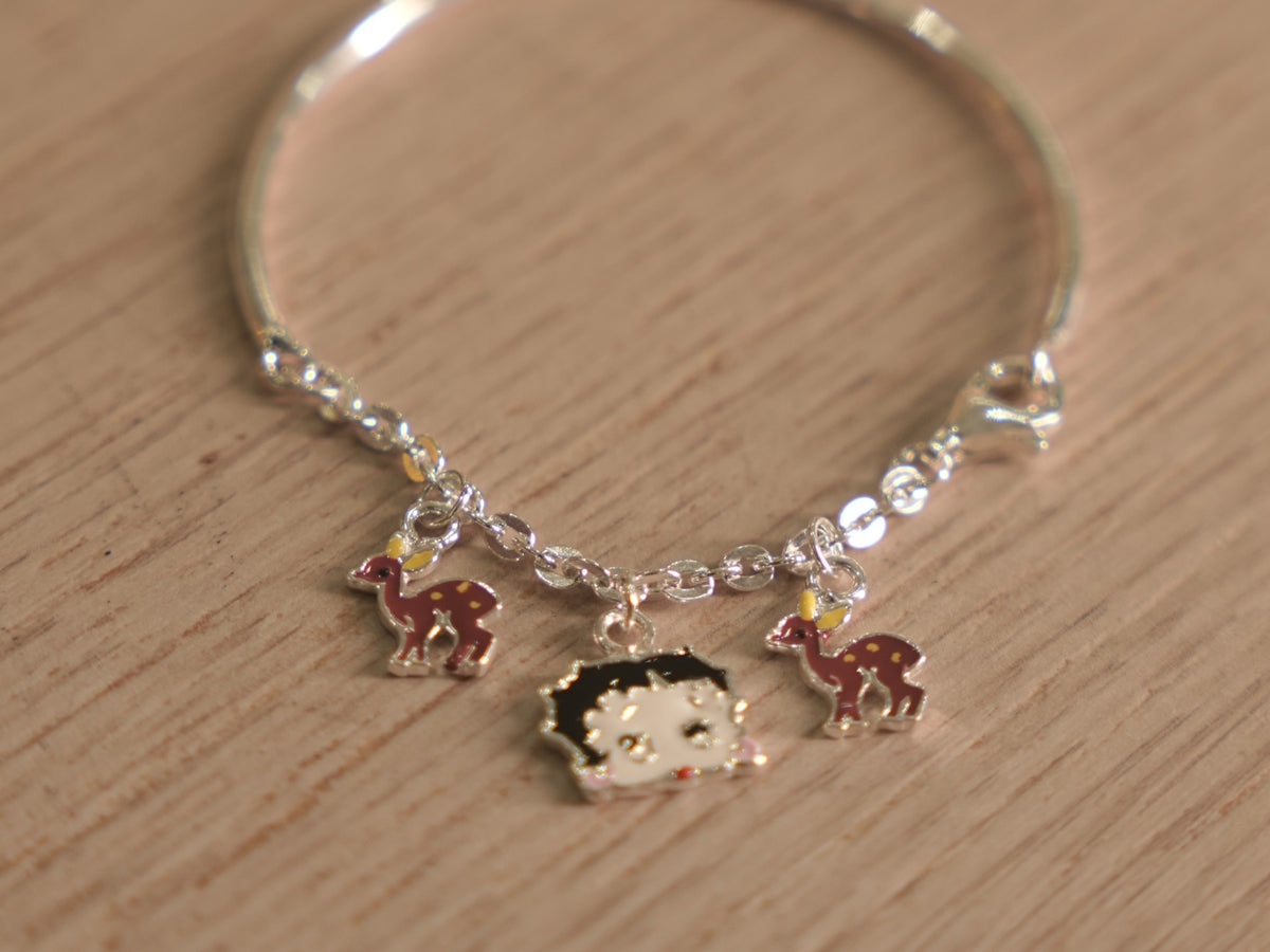 Close view of the spotted enamel deer charms on the kids bracelet chain.