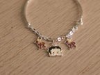 The kids charm bracelet showing the rigid band section and the hook where the chain closes.