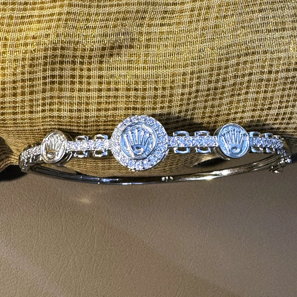 Close view of the three crown medallions and the pave set links between them.
