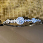 Close view of the three crown medallions and the pave set links between them.
