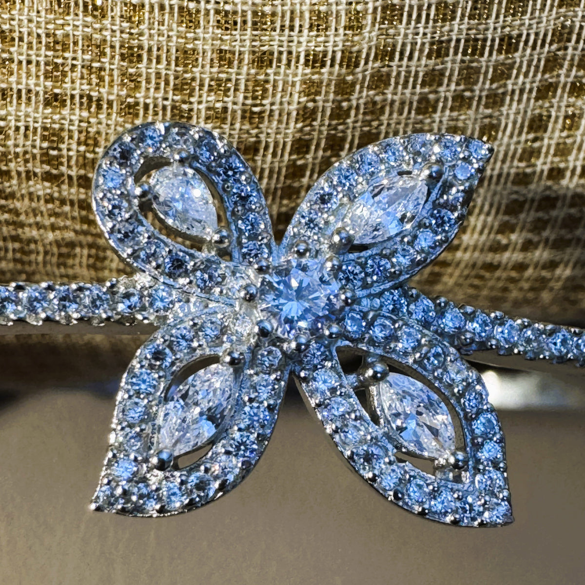 Close view of the four marquise petals and the round centre stone of the flower.