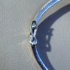 The hinge and box clasp on the plain polished half of the bangle.
