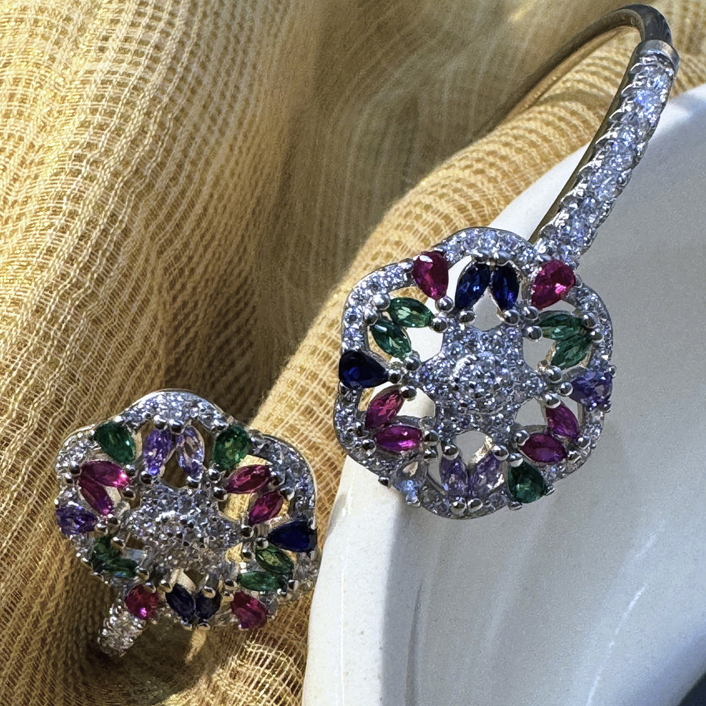 Close view of the pink, green, blue and purple marquise stones in the two flowers of the silver cuff.