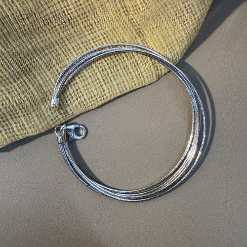 Five-strand sterling silver omega chain bracelet laid in a circle with the lobster clasp open.