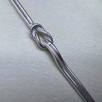 Close view of the knot and the fine texture of the snake chains.